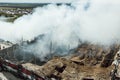 Burning industrial building. Smoke, collapsed roof, aerial view Royalty Free Stock Photo