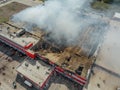 Burning industrial building. Smoke, collapsed roof aerial view Royalty Free Stock Photo