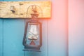 Burning kerosene lamp hang on the wooden wall