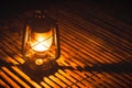 Burning kerosene old lamp on bamboo wooden, lighting in camping at night