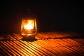 Burning kerosene old lamp on bamboo wooden, lighting in camping at night