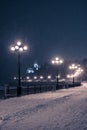 Burning lanterns of the evening embankment of the Amur River