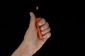 Burning lighter in female hand Royalty Free Stock Photo