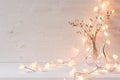 Burning lights and decoration on white wooden background. Royalty Free Stock Photo