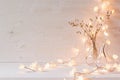 Burning lights and decoration on white wooden background.