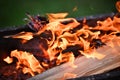 Burning log of wood close-up as abstract background. The hot embers of burning wood log fire. Royalty Free Stock Photo