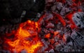 Burning log of wood close-up as abstract background. The hot embers of burning wood log fire. Firewood burning on grill. Royalty Free Stock Photo