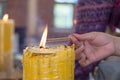 Burning many Incense sticks with large candle Royalty Free Stock Photo