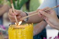 Burning many Incense sticks with large candle Royalty Free Stock Photo