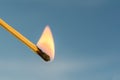 Burning match on a blue background Royalty Free Stock Photo