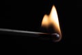 Burning match with a bright flame against a black background Royalty Free Stock Photo