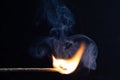 Burning match with a bright flame against a black background Royalty Free Stock Photo