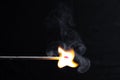 Burning match with a bright flame against a black background Royalty Free Stock Photo