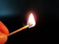Burning match in hand on neutral background Royalty Free Stock Photo