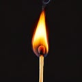 Burning match, isolated on black Royalty Free Stock Photo