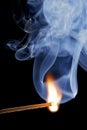Burning match over a black background, with smoke Royalty Free Stock Photo