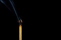 A burning match with smoke on a black background. Space for text. Royalty Free Stock Photo