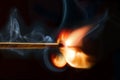 Burning matchstick, black background