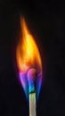 Burning matchstick with colorful flame on black background. Fire and heat concept Royalty Free Stock Photo