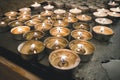 burning memorial candles on the dark background. many round memorial candles in the candlesticks. Burning fire on the candles Royalty Free Stock Photo