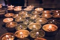 burning memorial candles on the dark background. many round memorial candles in the candlesticks. Burning fire on the candles Royalty Free Stock Photo