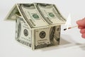 Burning money house made from dollars Royalty Free Stock Photo