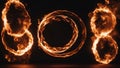 burning number eight fire hoop spinning in the darkness, creating a mesmerizing pattern of flames and smoke