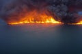 Burning Oil Spill, Huge Fire and Thick And Dense Smoke over an Oil Spill in the Sea