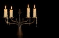 Burning old candle vintage bronze candlestick. Isolated Black Background. Royalty Free Stock Photo