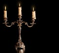 Burning old candle vintage bronze Silver candlestick. Isolated Black Background. Royalty Free Stock Photo