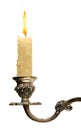 Burning old candle vintage bronze Silver candlestick. Isolated On White Background. Royalty Free Stock Photo