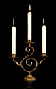 burning old candle vintage bronze candlestick. Isolated Black Background. Royalty Free Stock Photo