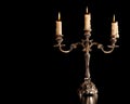 Burning old candle vintage Silver bronze candlestick. Isolated Black Background. Royalty Free Stock Photo