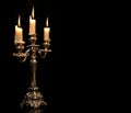 Burning old candle vintage Silver bronze candlestick. Isolated Black Background. Royalty Free Stock Photo