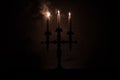 burning old candle vintage wooden candlestick. on dark toned foggy Background. Royalty Free Stock Photo