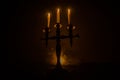 burning old candle vintage wooden candlestick. on dark toned foggy Background. Royalty Free Stock Photo