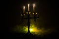 burning old candle vintage wooden candlestick. on dark toned foggy Background. Royalty Free Stock Photo