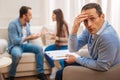 Exhausted male psychologist sitting during consultation