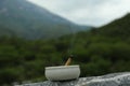 Burning palo santo stick on stone surface in high mountains