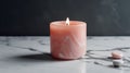 Burning pink candle on a white marble background. Copy space.