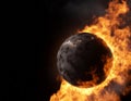 Burning planet made of coal set on fire and covered by flames on black background