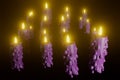 Burning purple candles for halloween 3d render.