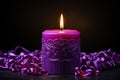 Burning purple candles with ribbons on wooden table, closeup