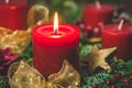Burning red candle in an advent arrangement with fresh fir branches, first advent Royalty Free Stock Photo