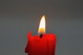 Burning red candle stub closeup Royalty Free Stock Photo