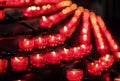 Lots of burning red candles in a church Royalty Free Stock Photo