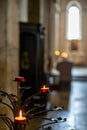 Burning  red candles in a church in Massa Marittima in Tuscany Royalty Free Stock Photo