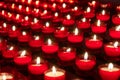 Burning red candles in church, selective focus, narrow deep of field Royalty Free Stock Photo