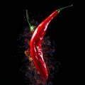 Burning red chili pepper on a black background. AI Royalty Free Stock Photo