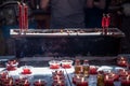 Burning red flower candle at chinese shrine for making merit. Lighting incense and candles for worship Buddha Royalty Free Stock Photo